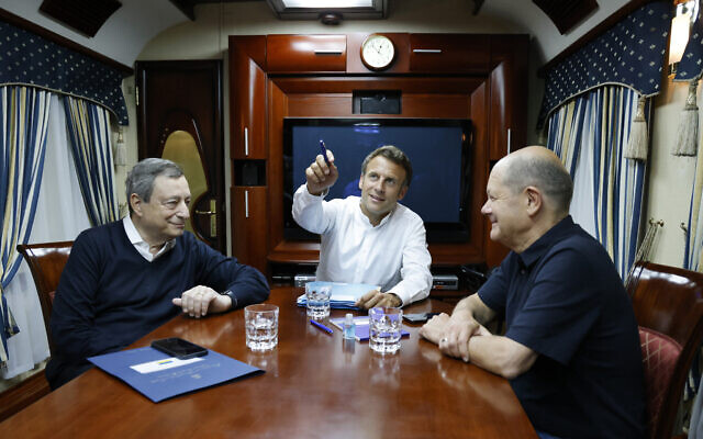 French President Emmanuel Macron, center, German Chancellor Olaf Scholz, right, and Italian Prime Minister Mario Draghi travel on board a train bound to Kyiv after departing from Poland, June 16, 2022 (Ludovic Marin, Pool via AP) French President Emmanuel Macron, center, German Chancellor Olaf Scholz, right, and Italian Prime Minister Mario Draghi travel on board a train bound to Kyiv after departing from Poland, June 16, 2022 (Ludovic Marin, Pool via AP)