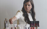 Revlon CEO Debra Perelman, the company's first woman CEO in its 89-year-old history, show products during an interview, August 18, 2021, in New York. (AP Photo/Bebeto Matthews, File)