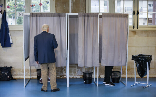 Voters make their choice in a voting booth in a voting station of Neuilly-sur-Seine, outside Paris, June 19, 2022 (AP Photo/Thomas Padilla) Voters make their choice in a voting booth in a voting station of Neuilly-sur-Seine, outside Paris, June 19, 2022 (AP Photo/Thomas Padilla)