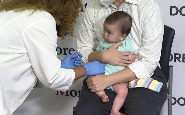 Ellen Fraint holds her daughter, seven-month-old Jojo, as she receives the first dose of the Moderna COVID-19 vaccine at Montefiore Medical Group in New York City on June 21, 2022. (AP Photo/Ted Shaffrey) Ellen Fraint holds her daughter, seven-month-old Jojo, as she receives the first dose of the Moderna COVID-19 vaccine at Montefiore Medical Group in New York City on June 21, 2022. (AP Photo/Ted Shaffrey)