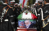 Military personnel stand near the flag-draped coffin of Mohsen Fakhrizadeh, a scientist who was killed on Friday, during a funeral ceremony in Tehran, Iran, November 30, 2020. (Iranian Defense Ministry via AP)