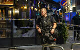Police stand guard at the site of a mass shooting in Oslo, early June 25, 2022. (Javad Parsa/NTB via AP)