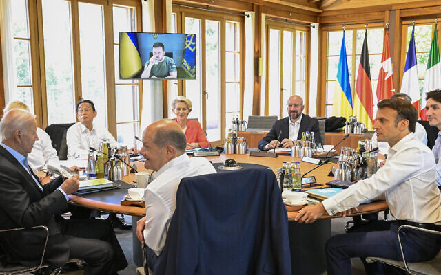 From front center clockwise, Germany's Chancellor Olaf Scholz, US President Joe Biden, Britain's Prime Minister Boris Johnson, Japan's Prime Minister Fumio Kishida, European Commission President Ursula von der Leyen, European Council President Charles Michel, Italy's Prime Minister Mario Draghi, Canada's Prime Minister Justin Trudeau and France's President Emmanuel Macron have taken seat at a round table as Ukraine's President Volodymyr Zelensky addresses the G7 leaders via video link during their working session at Castle Elmau in Kruen, near Garmisch-Partenkirchen, Germany, on June 27, 2022 (Tobias Schwarz/Pool Photo via AP)