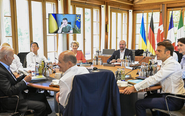 From front center clockwise, Germany's Chancellor Olaf Scholz, US President Joe Biden, Britain's Prime Minister Boris Johnson, Japan's Prime Minister Fumio Kishida, European Commission President Ursula von der Leyen, European Council President Charles Michel, Italy's Prime Minister Mario Draghi, Canada's Prime Minister Justin Trudeau and France's President Emmanuel Macron sitting at a round table as Ukraine's President Volodymyr Zelensky addresses the G7 leaders via video link during their working session at Castle Elmau in Kruen, near Garmisch-Partenkirchen, Germany, June 27, 2022. (Tobias Schwarz/Pool Photo via AP) From front center clockwise, Germany's Chancellor Olaf Scholz, US President Joe Biden, Britain's Prime Minister Boris Johnson, Japan's Prime Minister Fumio Kishida, European Commission President Ursula von der Leyen, European Council President Charles Michel, Italy's Prime Minister Mario Draghi, Canada's Prime Minister Justin Trudeau and France's President Emmanuel Macron sitting at a round table as Ukraine's President Volodymyr Zelensky addresses the G7 leaders via video link during their working session at Castle Elmau in Kruen, near Garmisch-Partenkirchen, Germany, June 27, 2022. (Tobias Schwarz/Pool Photo via AP)