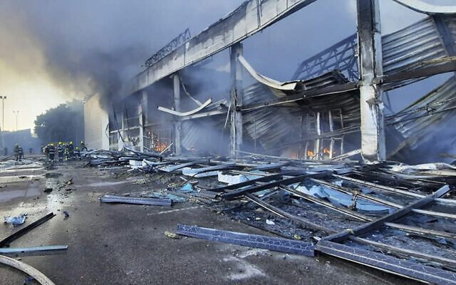 In this image made from video provided by Ukrainian State Emergency Service, firefighters work to extinguish a fire at a shopping center burned after a rocket attack that was allegedly carried out by Russia in Kremenchuk, Ukraine, on June 27, 2022. (Ukrainian State Emergency Service via AP)