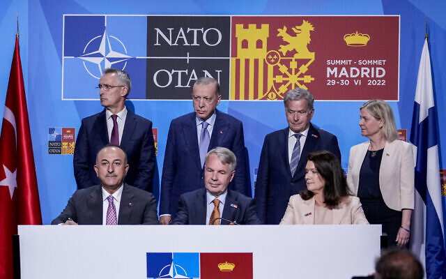 From left to right background: NATO Secretary General Jens Stoltenberg, Turkish President Recep Tayyip Erdogan, Finland's President Sauli Niinisto, Sweden's Prime Minister Magdalena Andersson, Turkish Foreign Minister Mevlut Cavusoglu, Finnish Foreign Minister Pekka Haavisto, and Sweden's Foreign Minister Ann Linde before signing a memorandum in which Turkey agrees to Finland and Sweden's membership of the defense alliance in Madrid, Spain on Tuesday, June 28, 2022. North Atlantic Treaty Organization heads of state will meet for a summit in Madrid from Tuesday through Thursday. (AP/Bernat Armangue) From left to right background: NATO Secretary General Jens Stoltenberg, Turkish President Recep Tayyip Erdogan, Finland's President Sauli Niinisto, Sweden's Prime Minister Magdalena Andersson, Turkish Foreign Minister Mevlut Cavusoglu, Finnish Foreign Minister Pekka Haavisto, and Sweden's Foreign Minister Ann Linde before signing a memorandum in which Turkey agrees to Finland and Sweden's membership of the defense alliance in Madrid, Spain on Tuesday, June 28, 2022. North Atlantic Treaty Organization heads of state will meet for a summit in Madrid from Tuesday through Thursday. (AP/Bernat Armangue)