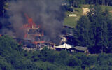 This image taken from video provided by WJLA shows crews battling a fire at Camp Airy for Boys in Thurmont, Md., on June 29, 2022. (WJLA via AP)