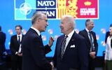 NATO Secretary General Jens Stoltenberg, left, speaks with US President Joe Biden during a round table meeting at a NATO summit in Madrid, Spain on June 30, 2022. (AP Photo/Bernat Armangue)