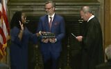 Chief Justice of the United States John Roberts (right) administers the Constitutional Oath to Ketanji Brown Jackson as her husband, Patrick Jackson, holds the Bible at the Supreme Court in Washington, June 30, 2022. (Supreme Court via AP)