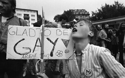 A thirty-year-old Dutch demonstrator displays a sign that reads: "Glad to be Gay" during a gay people march in Frankfurt, Germany on July 28, 1979. (AP Photo/Rolf Boehm)