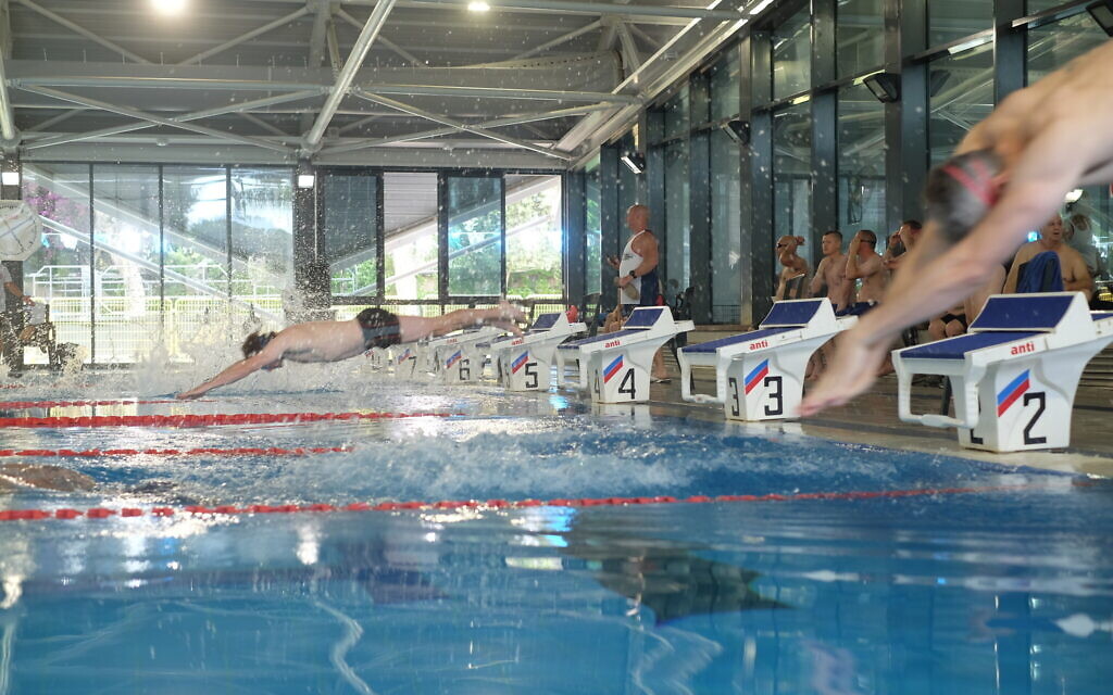 Swimmers dive into a pool during a meet as part of the British-Israeli Veterans Games in Tel Aviv on May 30, 2022. (Judah Ari Gross/Times of Israel) Swimmers dive into a pool during a meet as part of the British-Israeli Veterans Games in Tel Aviv on May 30, 2022. (Judah Ari Gross/Times of Israel)