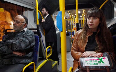 Illustrative: Secular Israelis board a gender-segregated bus where women sit in the back of the bus, and men in the front. The secular women sat among ultra-Orthodox Jewish men in the front, as part of a protest against the exclusion of women in the public sphere, January 1, 2012. (Miriam Alster / Flash90)
