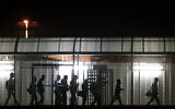 Illustrative: Palestinians holding Israeli work permits crossing from the West Bank into Israel through the Eyal checkpoint, near the West Bank city of Qalqilya. November 21, 2013. (Miriam Alster/Flash90)