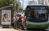 Israelis board a Kavim bus on the main street in the central city of Petah Tikva, June 24, 2015. (Nati Shohat/Flash90)