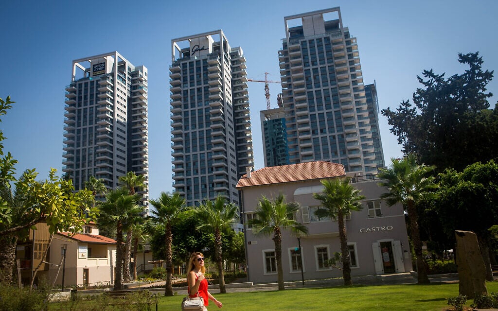 A young woman walks in front of residential towers in Tel Aviv's Sarona neighborhood in Tel Aviv, August 18, 2015. (Miriam Alster/Flash90) A young woman walks in front of residential towers in Tel Aviv's Sarona neighborhood in Tel Aviv, August 18, 2015. (Miriam Alster/Flash90)