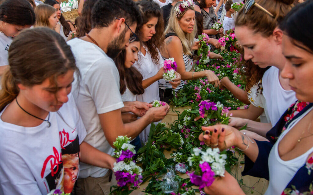 Israelis seen at a celebration for the Jewish holiday of Shavuot in Moshav Kfar Yedidia on June 9, 2019. (Flash90)