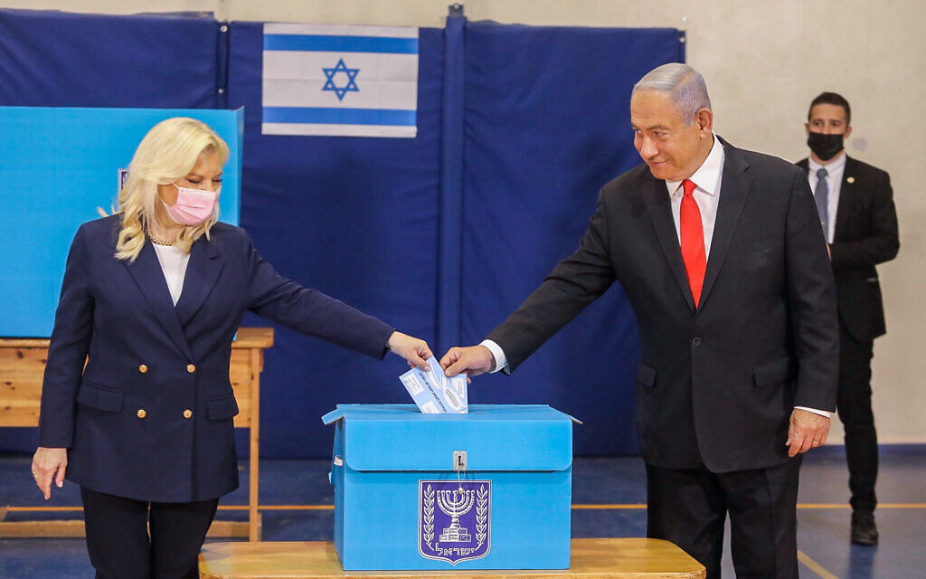 Then prime minister Benjamin Netanyahu casts his vote, together with his wife Sara, at a voting station in Jerusalem, during the Knesset elections on March 23, 2021. (Marc Israel Sellem/POOL) Then prime minister Benjamin Netanyahu casts his vote, together with his wife Sara, at a voting station in Jerusalem, during the Knesset elections on March 23, 2021. (Marc Israel Sellem/POOL)