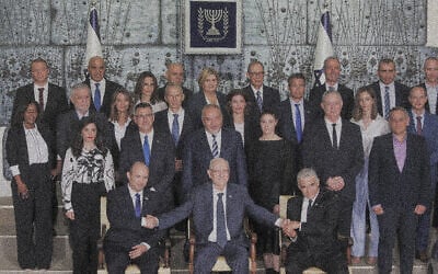 Prime Minister Naftali Bennett, Foreign Minister Yair Lapid, President Reuven Rivlin and ministers pose for a group photo of the newly sworn-in government at the President's Residence in Jerusalem on June 14, 2021. (Yonatan Sindel/Flash90)
