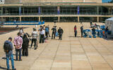 People stand in line to be tested for the COVID-19, at a testing center on HaBima square in Tel Aviv, on March 28, 2022. (Yossi Aloni/Flash90)