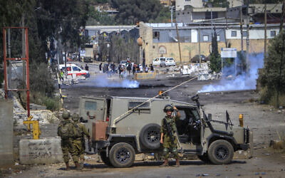 Illustrative: Palestinians clash with Israeli security forces during a protest in the village of Beit Dajan, near the West Bank city of Nablus, June 3, 2022. (Nasser Ishtayeh/Flash90)