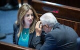 Meretz MK Ghaida Rinawie Zoabi (L) speaks with Ra'am MK Mazen Ghanaim (R) during a Knesset discussion on a bill to renew the application of some Israeli law to settlers, June 6, 2022. (Yonatan Sindel/Flash90)