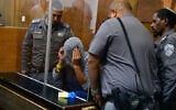 A man suspected of murdering his son's father-in-law arrives for a court hearing at the Tel Aviv Magistrate's Court on June 19, 2022. (Avshalom Sassoni/Flash90)