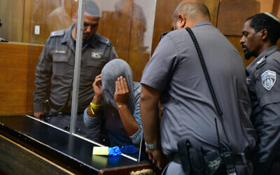 A man suspected of murdering his son's father-in-law arrives for a court hearing at the Tel Aviv Magistrate's Court on June 19, 2022. (Avshalom Sassoni/Flash90)