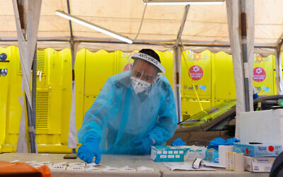 A Magen David worker takes a COVID-19 rapid antigen test in Jerusalem, on June 20, 2022. (Olivier Fitoussi/Flash90)