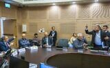 MK Gilad Kariv, left, motions as MK Itamar Ben Gvir is led out of a Knesset committee meeting on June 26, 2022. (Olivier FItoussi/Flash90)
