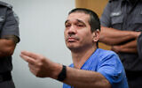 Yitzhak Abergil, convicted of murdering 3 bystanders during an attempted assassination of a rival, receives his sentence at the Tel Aviv District Court, June 28, 2022. (Avshalom Sassoni/Flash90)