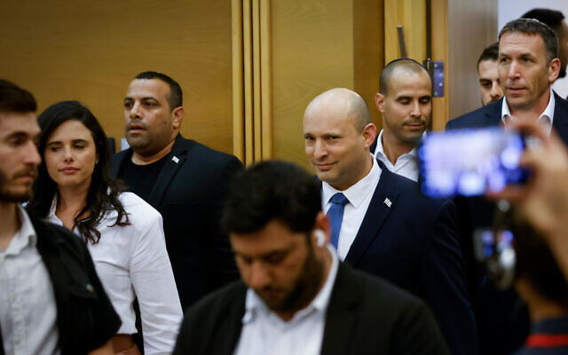 Outgoing Prime Minister Naftali Bennett pictured at a press conference at which he announced he will not be running in the next elections. At left is Ayelet Shaked, the new Yamina party leader. June 29, 2022. (Olivier Fitoussi/Flash90) Outgoing Prime Minister Naftali Bennett pictured at a press conference at which he announced he will not be running in the next elections. At left is Ayelet Shaked, the new Yamina party leader. June 29, 2022. (Olivier Fitoussi/Flash90)