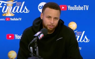 Stephen Curry sporting a sweatshirt with Hebrew on it during an NBA Finals postgame press conference, June 10, 2022. (Screenshot from YouTube via JTA)