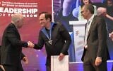 Quentin Tarantino, center, shakes hands with Hebrew University President Asher Cohen as Hebrew University Rector Barak Medina looks on at the awarding of an honorary degree on June 13, 2022. (Hebrew University/Bruno Cherbit)
