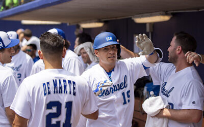 Team Israel's Danny Valencia high-fives teammates in this undated photo. (Courtesy IAB)