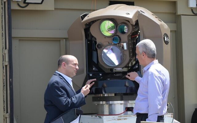 Prime Minister Naftali Bennett (left) is shown a new laser-based air-defense system at a Rafael weapons manufacturer complex in Israel, on May 31, 2022. (Amos Ben Gershom/GPO) Prime Minister Naftali Bennett (left) is shown a new laser-based air-defense system at a Rafael weapons manufacturer complex in Israel, on May 31, 2022. (Amos Ben Gershom/GPO)