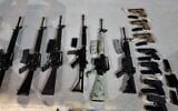 Weapons seized by security forces near Neot Hakikar in southern Israel, after an alleged gun-smuggling over the border with Jordan on June 20, 2022. (Israel Police)