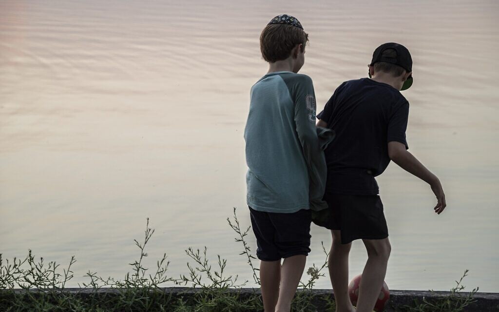Children play near the lake near a camp for Ukrainian Jewish refugees in Balatonőszöd, Hungary, in June 2022. (Courtesy of EMIH)