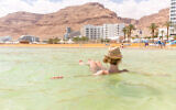 A woman floats in the Dead Sea at Ein Bokek. Illustrative. (Subbotsky via iStock by Getty Images)