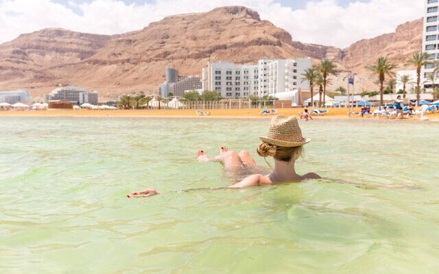 A woman floats in the Dead Sea at Ein Bokek. Illustrative. (Subbotsky via iStock by Getty Images)
