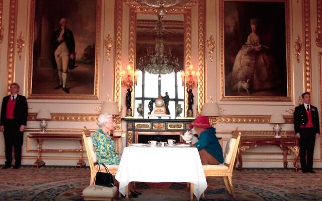 Queen Elizabeth II and Paddington Bear in a video released by the Royal Family ahead of a London concert held as part of the Platinum Jubilee celebrations, June 4, 2022. (Screen grab/BBC) Queen Elizabeth II and Paddington Bear in a video released by the Royal Family ahead of a London concert held as part of the Platinum Jubilee celebrations, June 4, 2022. (Screen grab/BBC)
