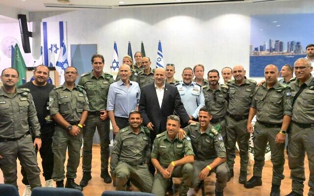 Prime Minister Naftali Bennett (center), Police Commisoner Kobi Shabtai (right), Public Securiry Minister Omer Barlev (left) stand with Border Police officers at an Israel Police station, June 21, 2022. (Amos Ben Gershom/GPO) Prime Minister Naftali Bennett (center), Police Commisoner Kobi Shabtai (right), Public Securiry Minister Omer Barlev (left) stand with Border Police officers at an Israel Police station, June 21, 2022. (Amos Ben Gershom/GPO)