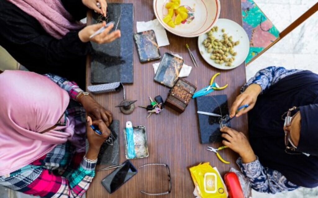 Libyan women craft traditional filigree jewellery at a workshop in the capital Tripoli, June 8, 2022. (Mahmud Turkia/AFP) Libyan women craft traditional filigree jewellery at a workshop in the capital Tripoli, June 8, 2022. (Mahmud Turkia/AFP)