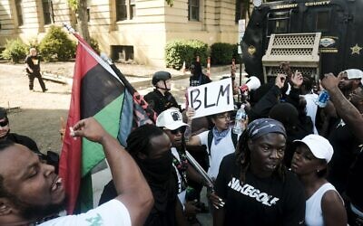 Sheriff officers in riot gear face  demonstrators gathered outside Akron City Hall to protest the killing of Jayland Walker, shot by police, in Akron, Ohio, July 3, 2022.  (Matthew Hatcher / AFP)