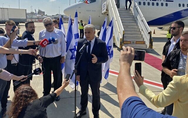 Prime Minister Yair Lapid speaks to the press ahead of his first overseas trip as PM, to Paris, at Ben Gurion Airport on July 5, 2022. (Guillaume LAVALLÉE / AFP) Prime Minister Yair Lapid speaks to the press ahead of his first overseas trip as PM, to Paris, at Ben Gurion Airport on July 5, 2022. (Guillaume LAVALLÉE / AFP)