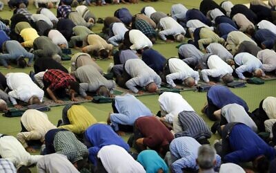 Iranian worshippers take part in the morning prayer ceremony for Eid al-Adha, celebrated by Muslims worldwide, at Tehran's Imam Khomeini Mosalla mosque, on July 10, 2022. (AFP)