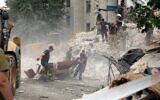 Rescuers clear the scene after a building was partially destroyed following shelling in Chasiv Yar, eastern Ukraine, on July 10, 2022. (Anatolii Stepanov / AFP)