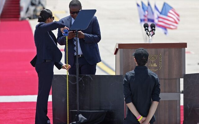 Officials prepare the podium at Israel's Ben Gurion Airport in Lod near Tel Aviv, on July 13, 2022, ahead of US President Joe Biden's arrival for an official visit. (Photo by Jack Guez / AFP)