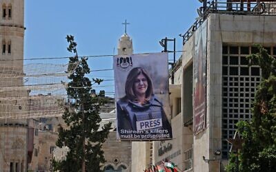 Banners depicting slain Palestinian-American journalist Shireen Abu Akleh hang on a building overlooking the Church of the Nativity in Bethlehem in the West Bank, on July 14, 2022. (Ahmad Gharabli/AFP)