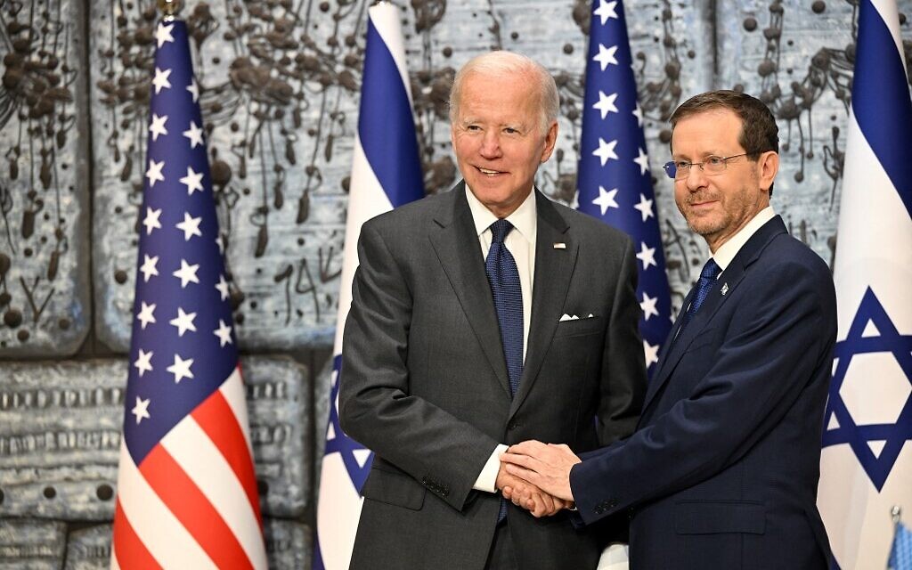 US President Joe Biden shakes hands with President Isaac Herzog (R) at the President's Residence in Jerusalem on July 14, 2022. (MANDEL NGAN/AFP)