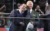 US President Joe Biden (R) embraces President Isaac Herzog (L) during the opening ceremony of the Maccabiah Games at Teddy Stadium in Jerusalem on July 14, 2022. (RONEN ZVULUN / POOL / AFP)